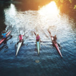 Team of People Rowing Representing a Team that Works Together