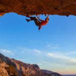 Man Climbing Representing High Performance in Difficult Times