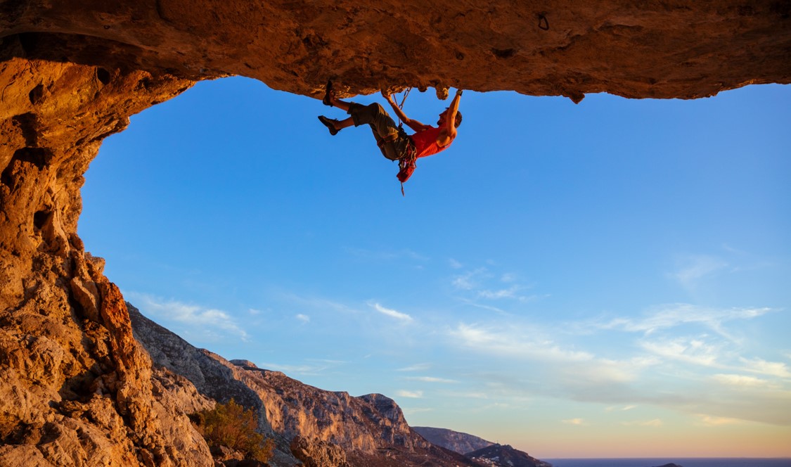Man Climbing Representing High Performance in Difficult Times
