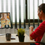 Woman talking with colleagues on webcam